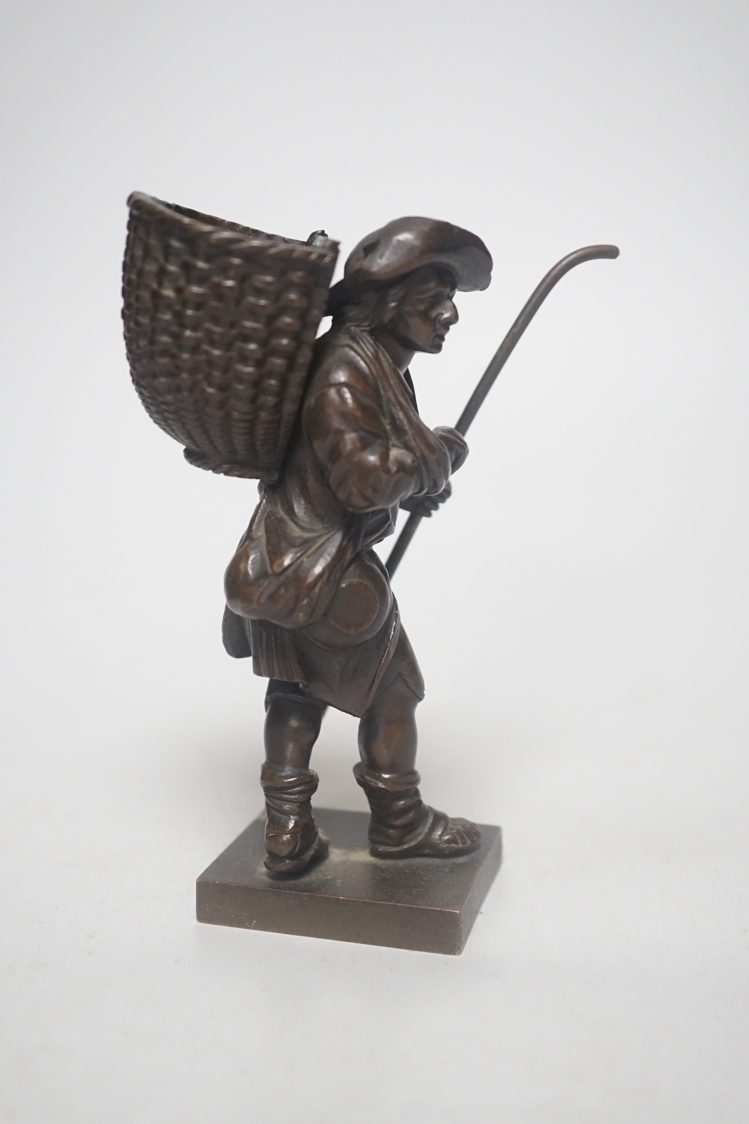 A 20th century bronze of a travelling salesman. 15cm tall